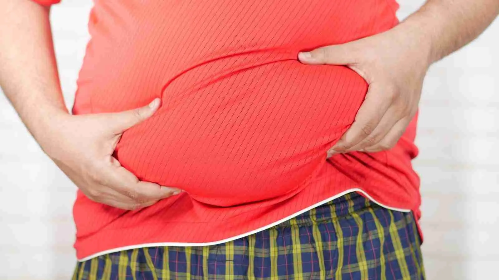 Close-up Photo of Person holding his Belly