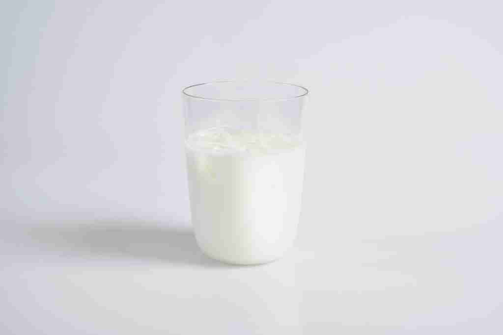 white liquid in clear drinking glass