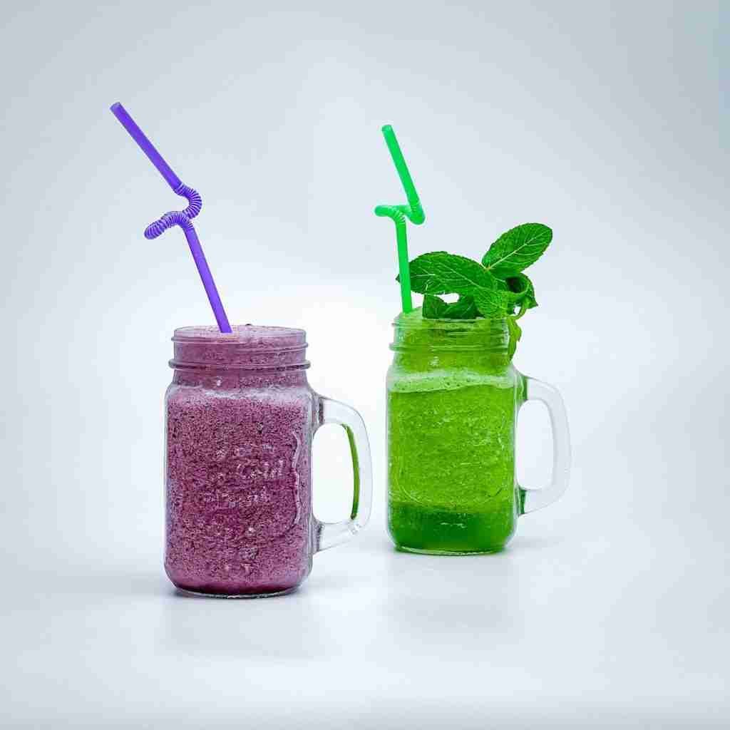 a couple of mason jars filled with green colored drinks