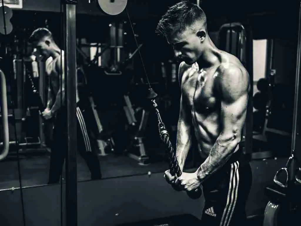 grayscale photo of man exercising (Tricep Pushdowns)