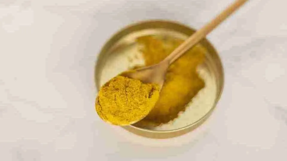 Turmeric powder with a spoon