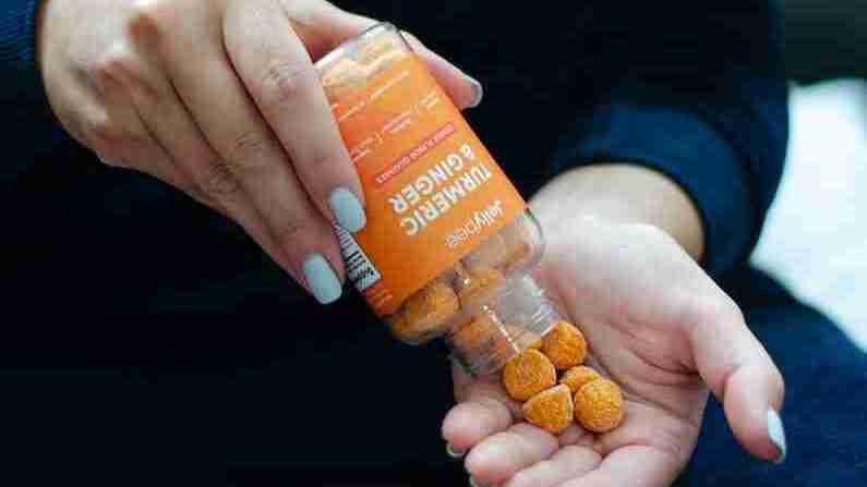 person holding Turmeric Gummies  bottle
