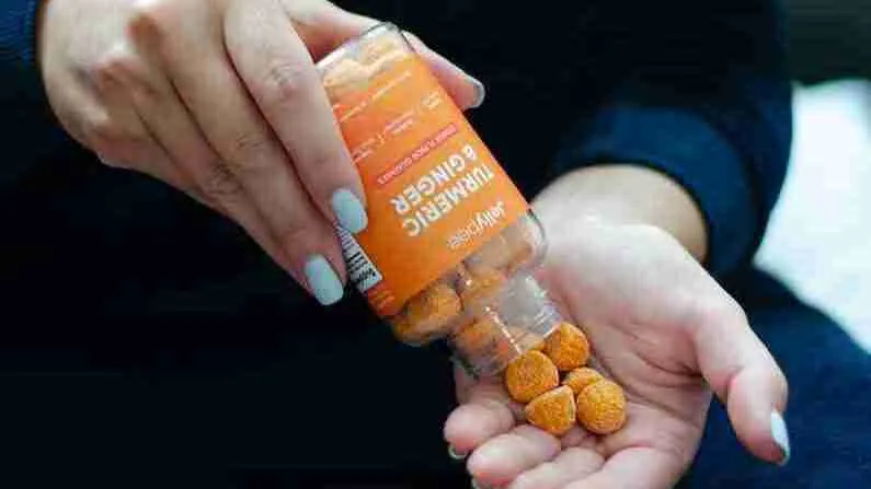 person holding Turmeric Gummies  bottle