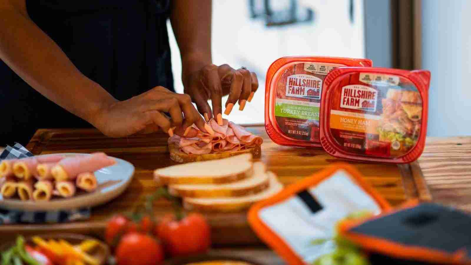 Person making a ham sandwich