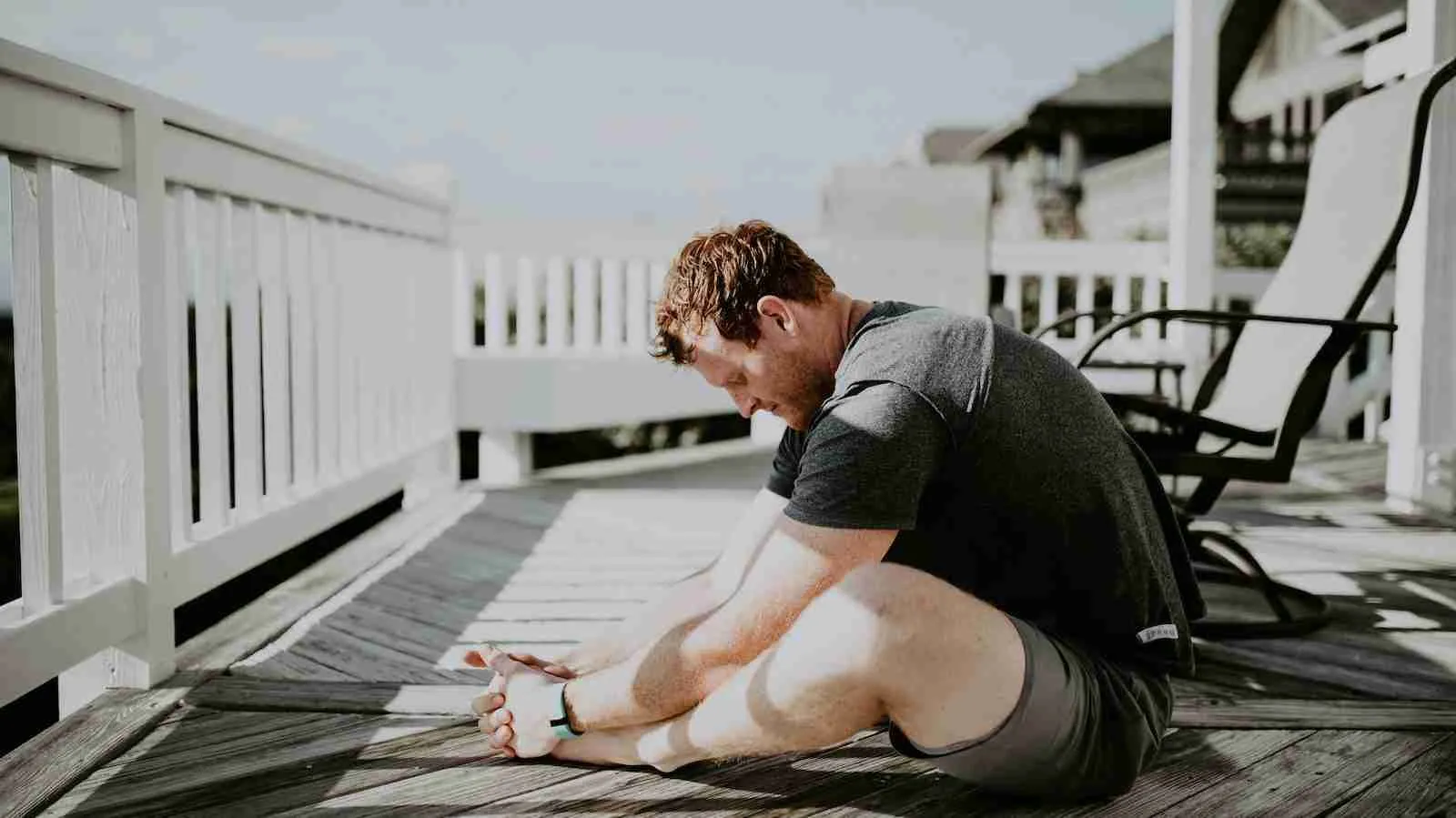 man doing yoga in porch