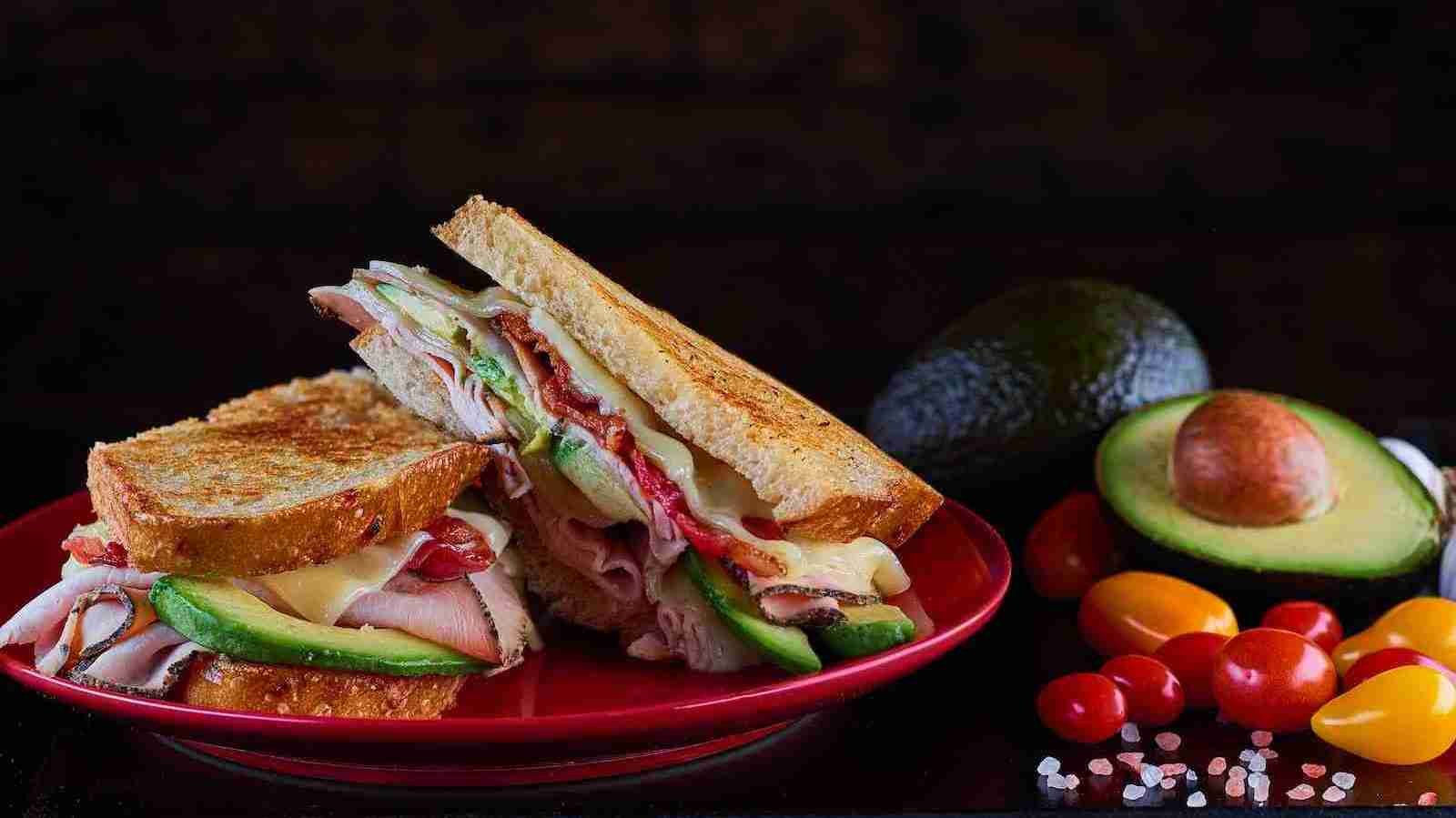 Ham sandwich on red ceramic plate