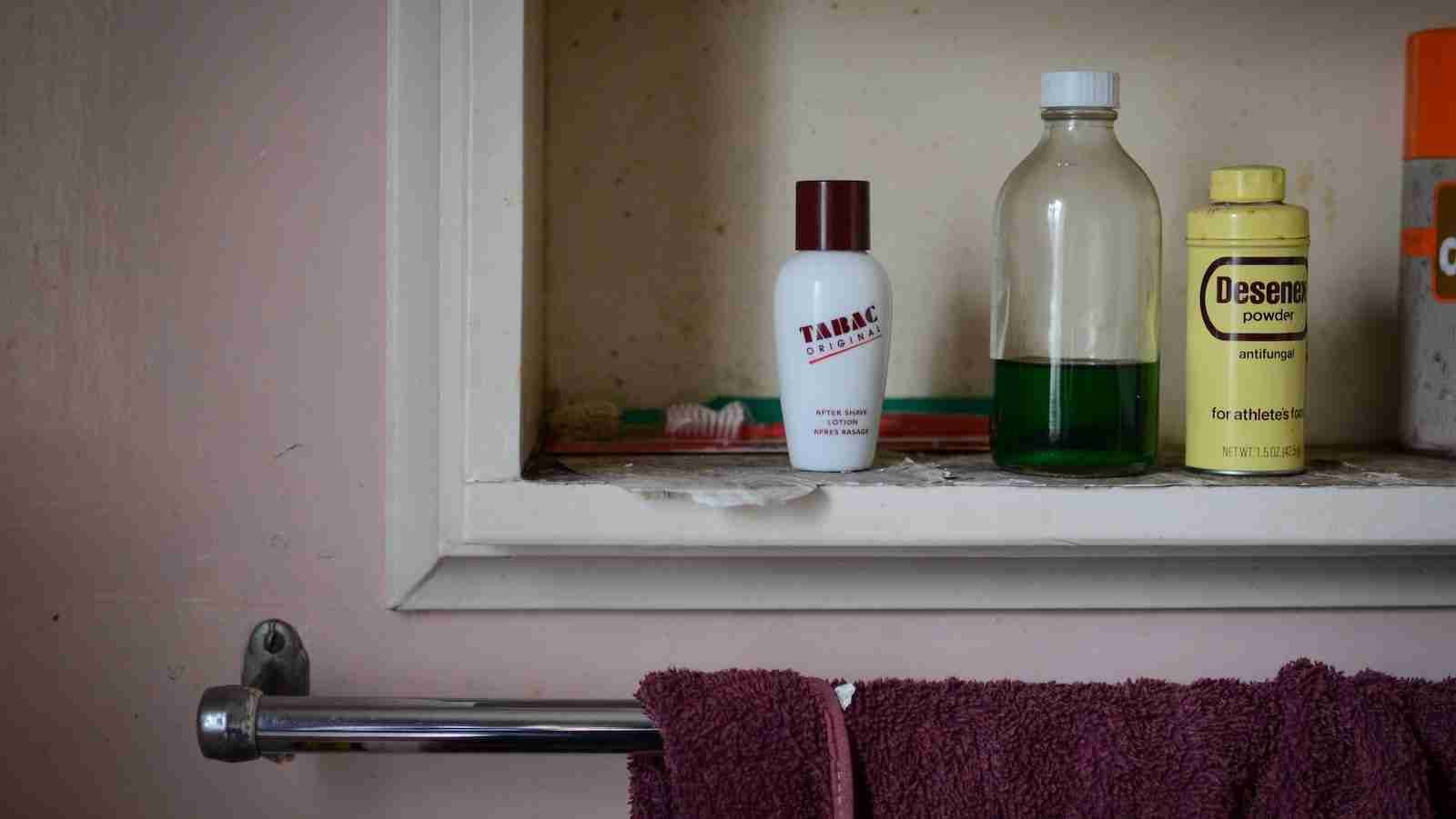 red towel hanged on stainless steel rack