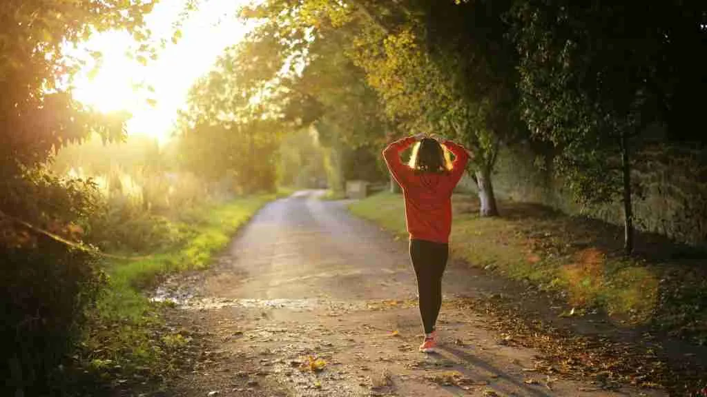 woman walking on pathway during daytime