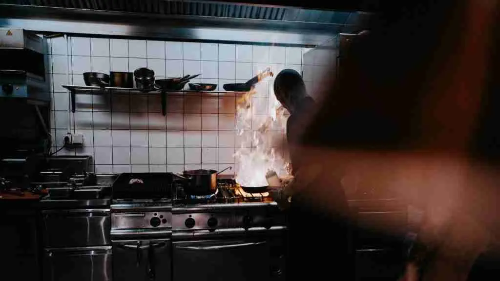 person doing cook inside kitchen