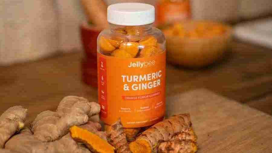 Turmeric Gummies Bottle placed with turmeric