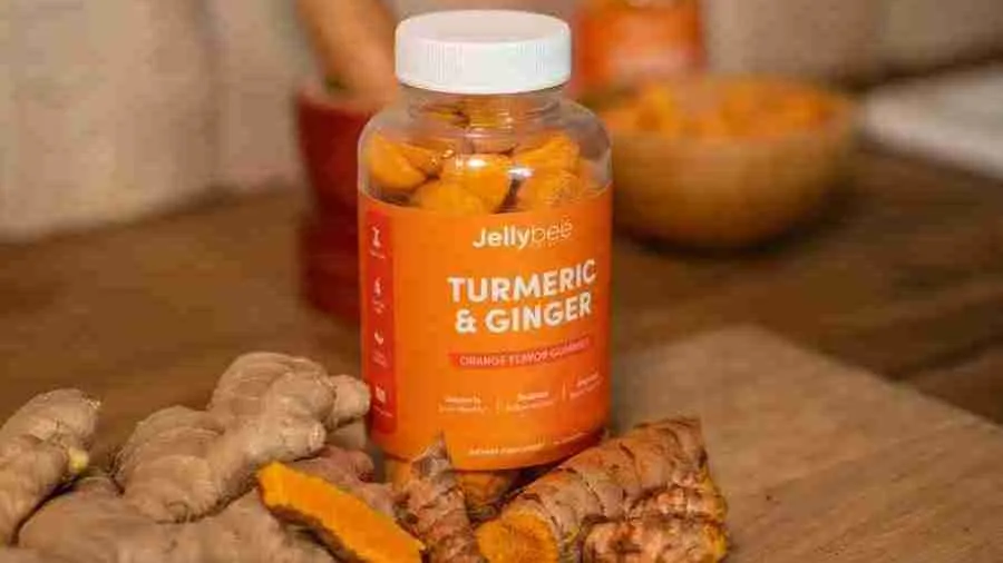 Turmeric Gummies Bottle placed with turmeric