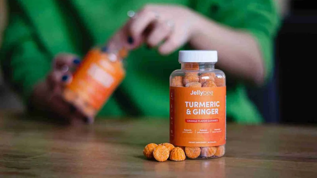 person holding a Turmeric gummies bottle.