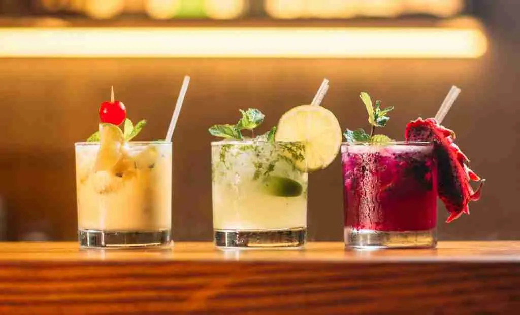 three clear glass cups with juice