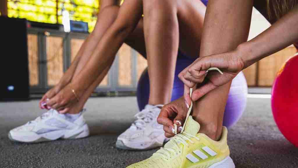 a pair of people tying their shoes