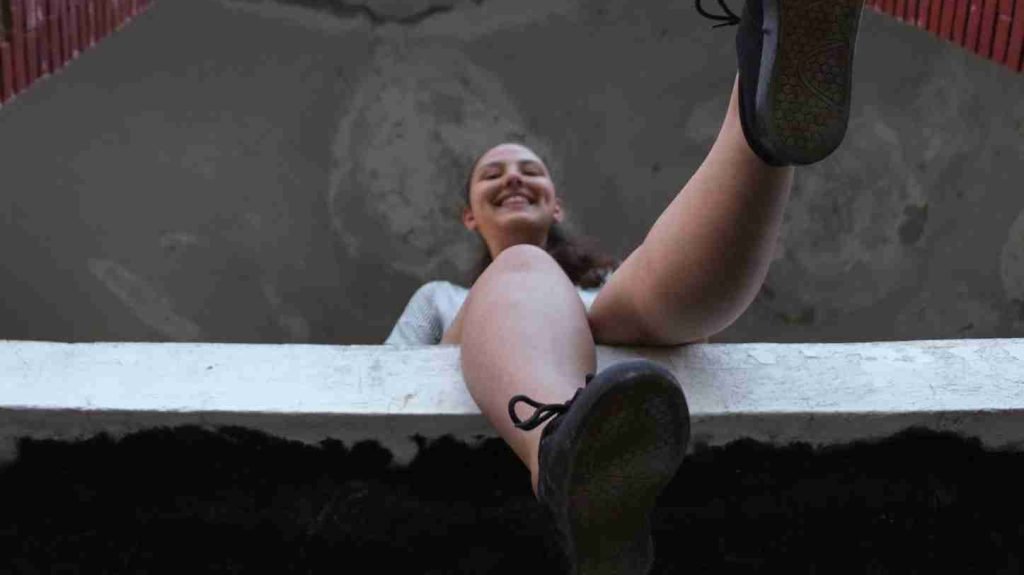A photograph of a woman posing her sole of the shoes