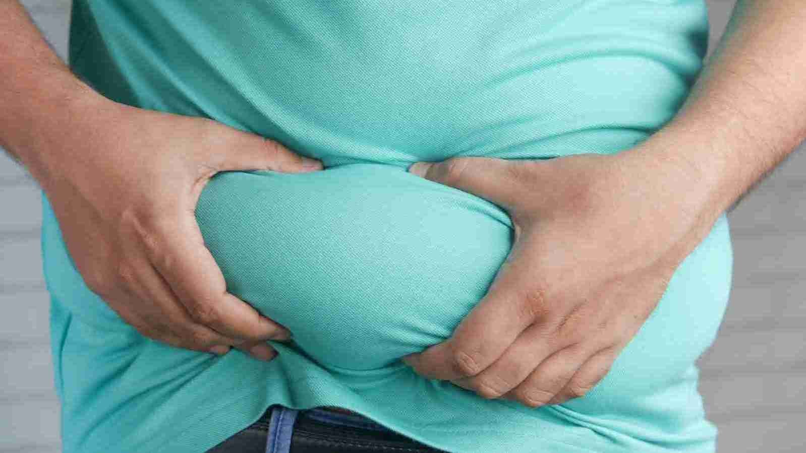 a man holding his stomach with his hands