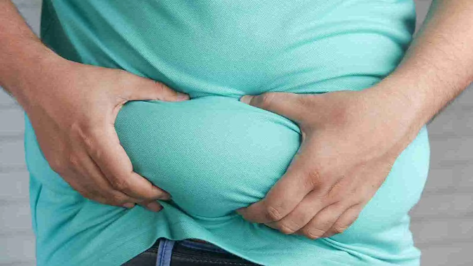 a man holding his stomach with his hands