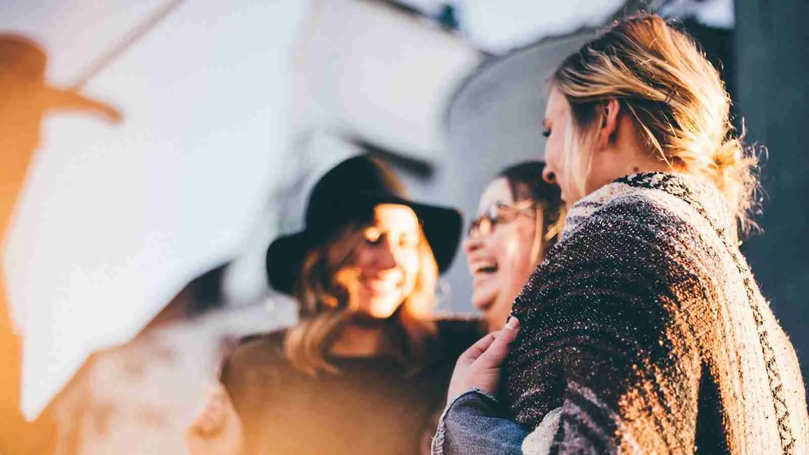 people laughing and talking outside during daytime