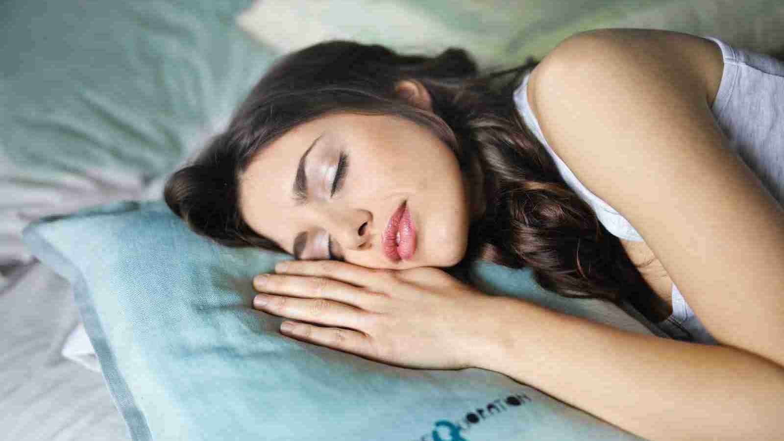 woman sleeping on blue throw pillow