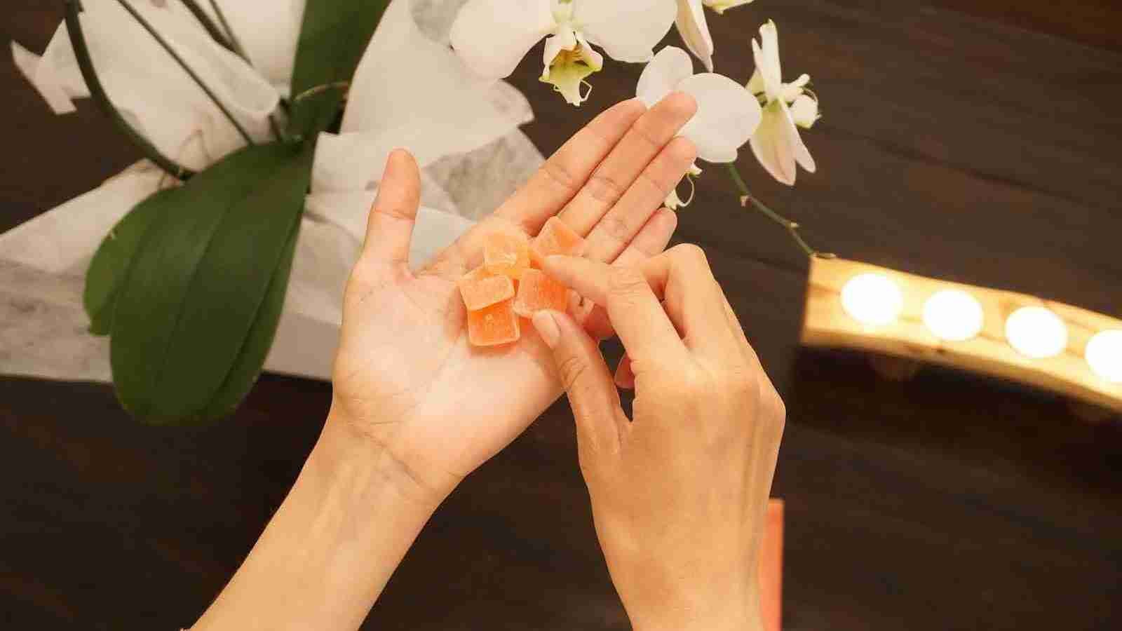 a person holding gummies in their hand
