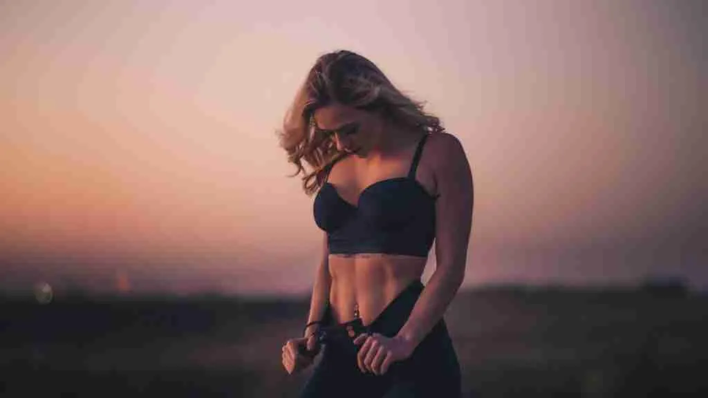 A fit women showing her abs