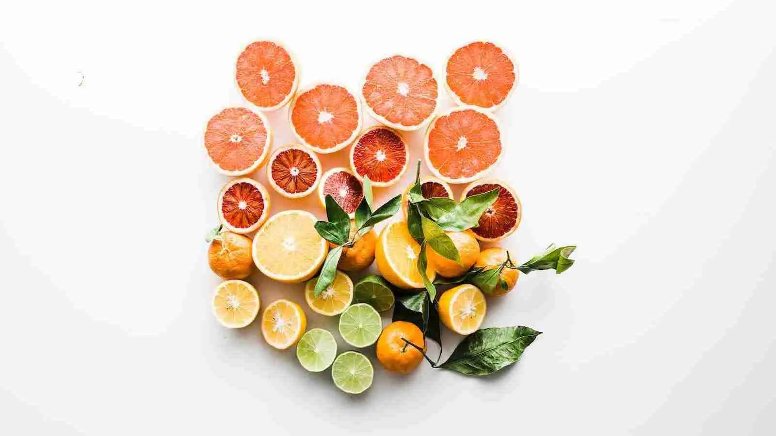 sliced citrus fruits on white surface