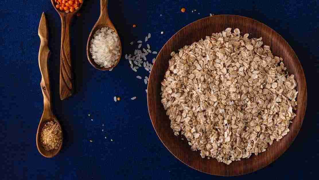 Oatmeal in a bowl with wooden spoons