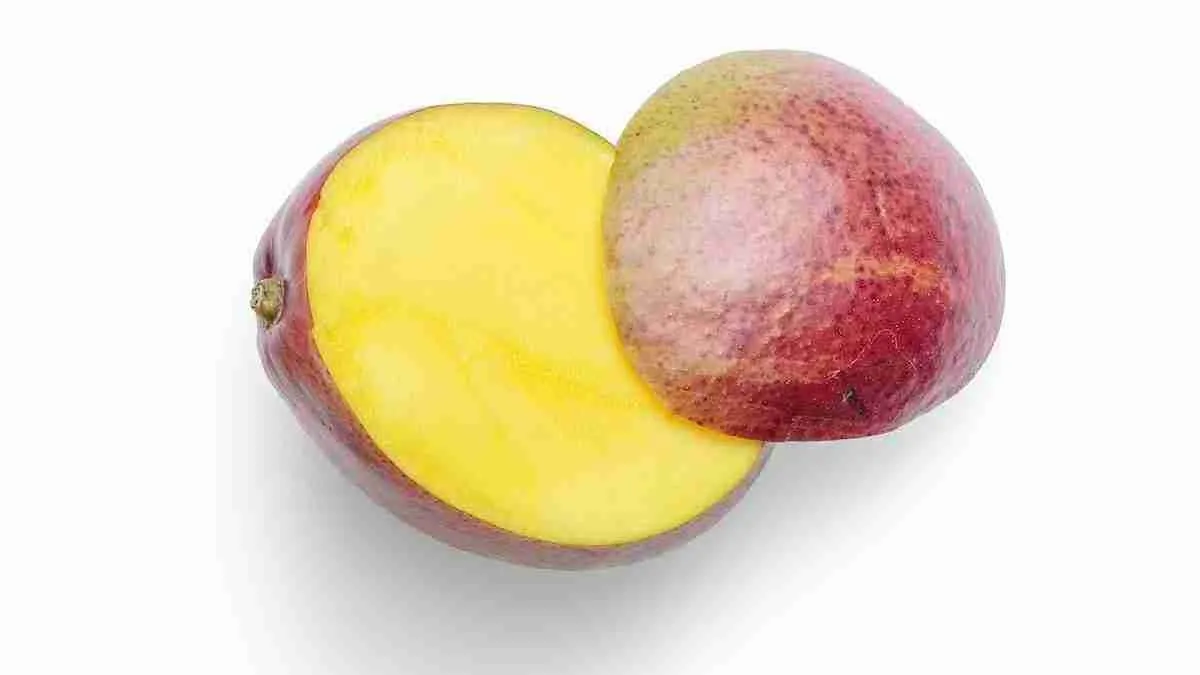 a piece of mango fruit with a bite taken out of it