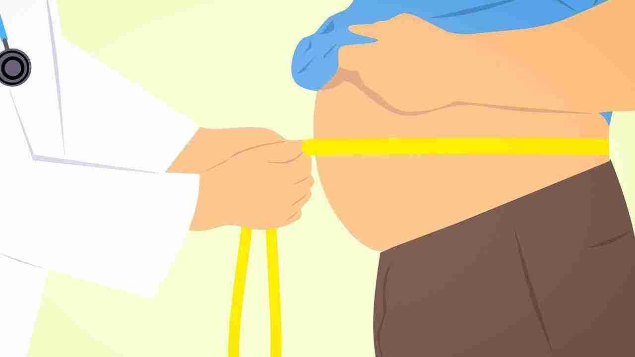 Physician measuring a vest and he seems bloated 