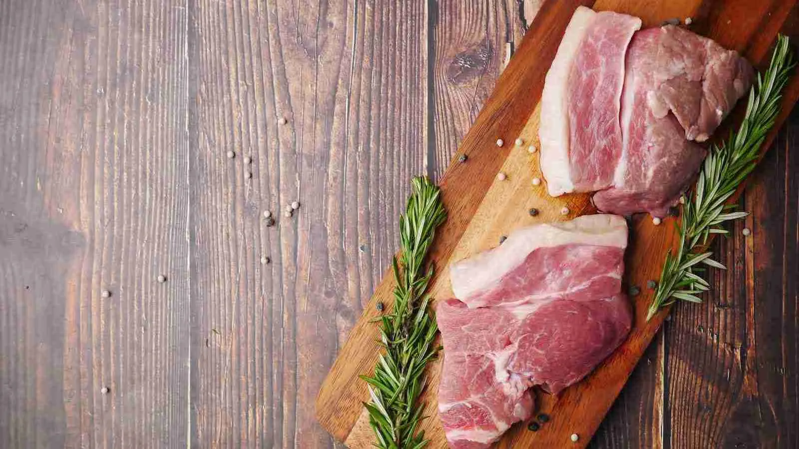 raw meat on brown wooden chopping board