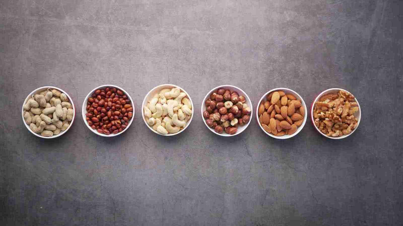 almonds and nuts on white ceramic bowls