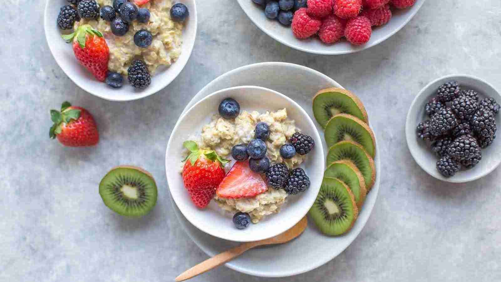 assorted fruits in bowls with oatmeal