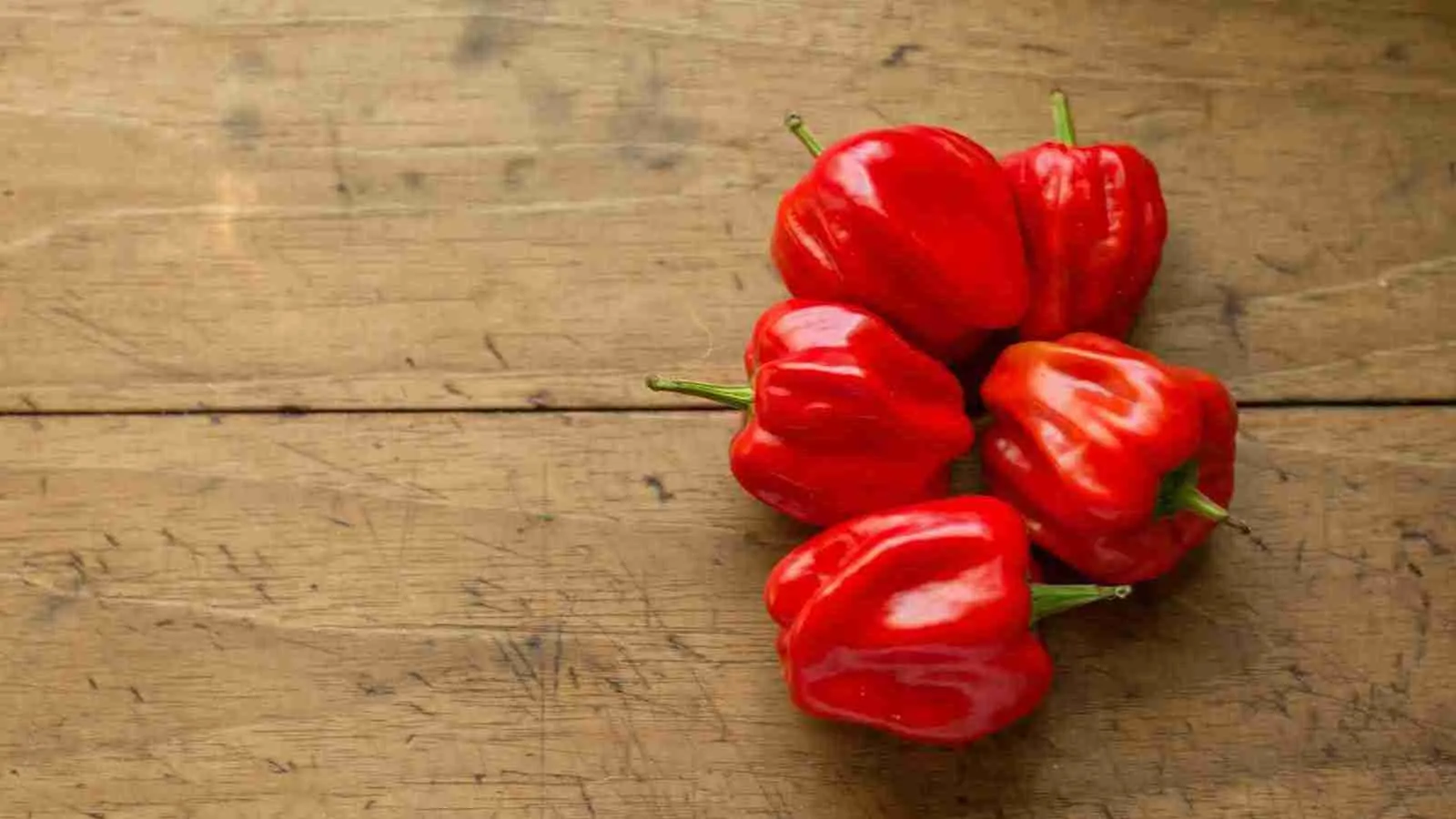 red bell peppers on brown surface