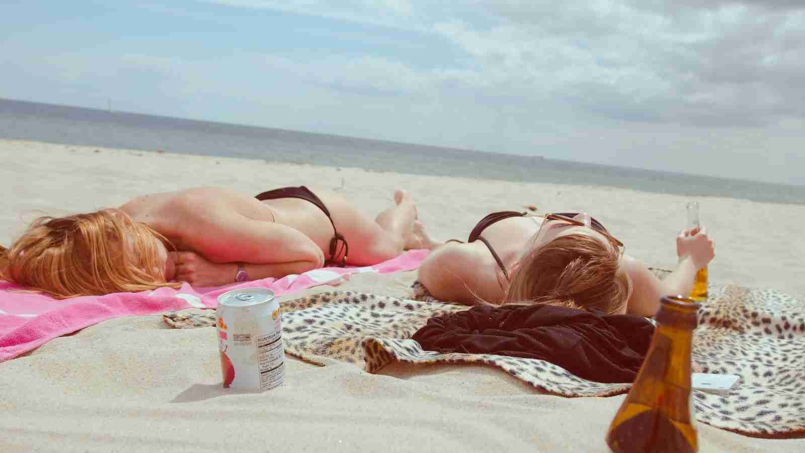 women bathing in the sun on a beach