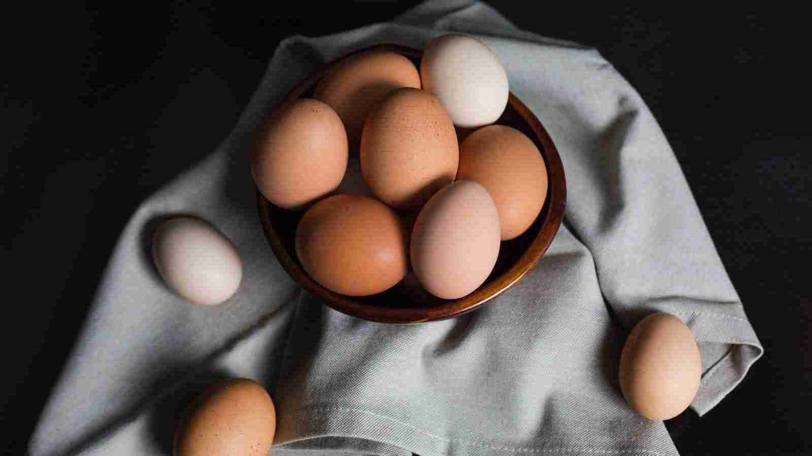 beige and white eggs on brown wooden bowl