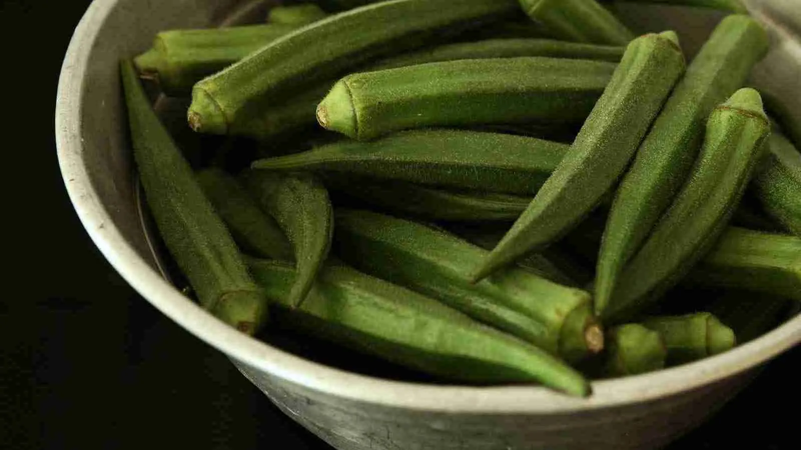 Okra vegetable in white bowl