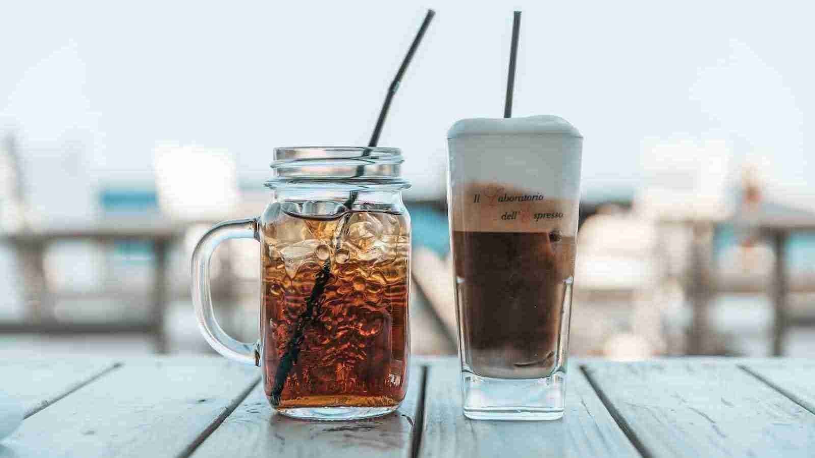 a glass of sweet iced tea next to a jar of  sweet iced tea