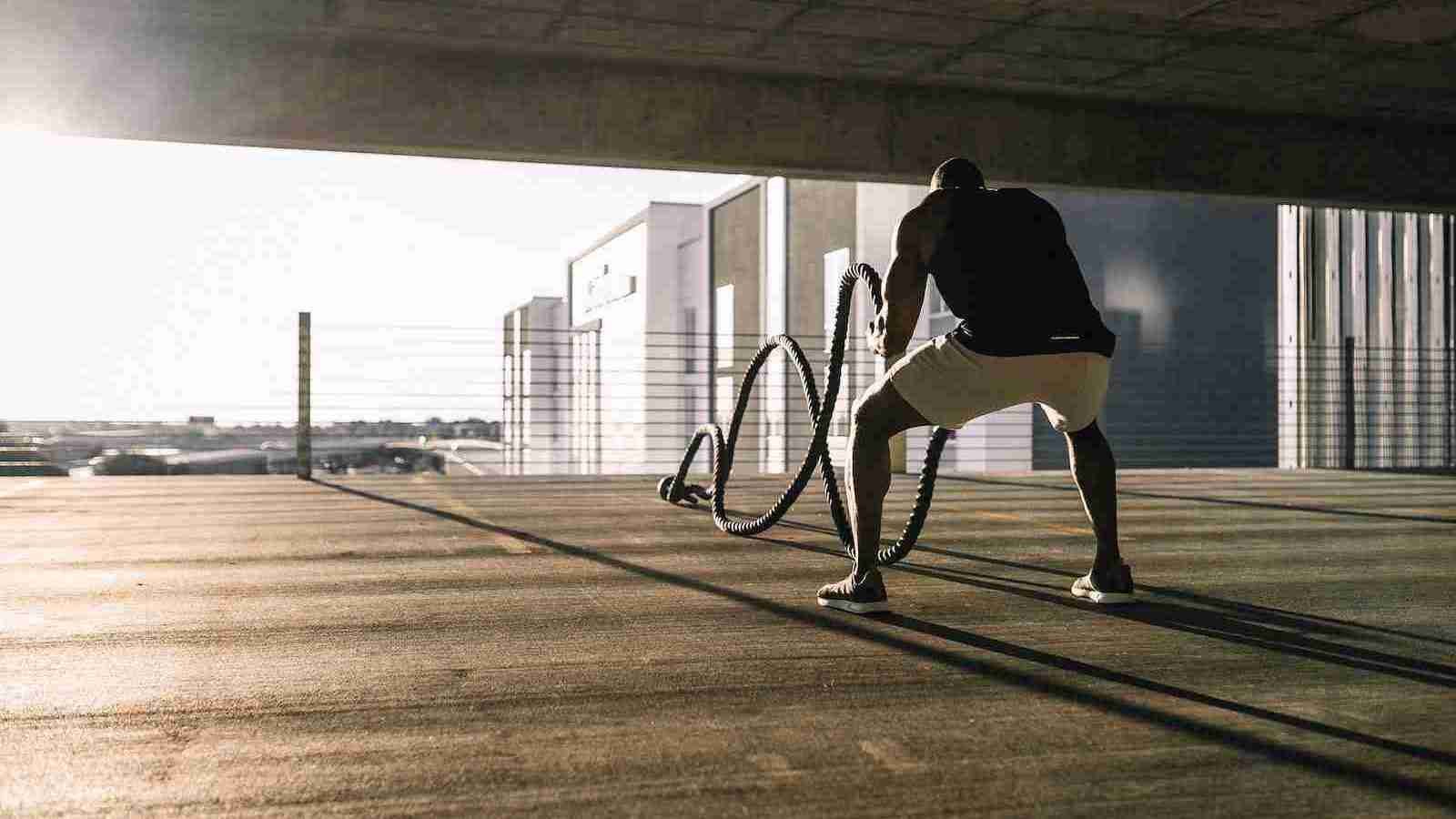 A man doing exercise with a rope