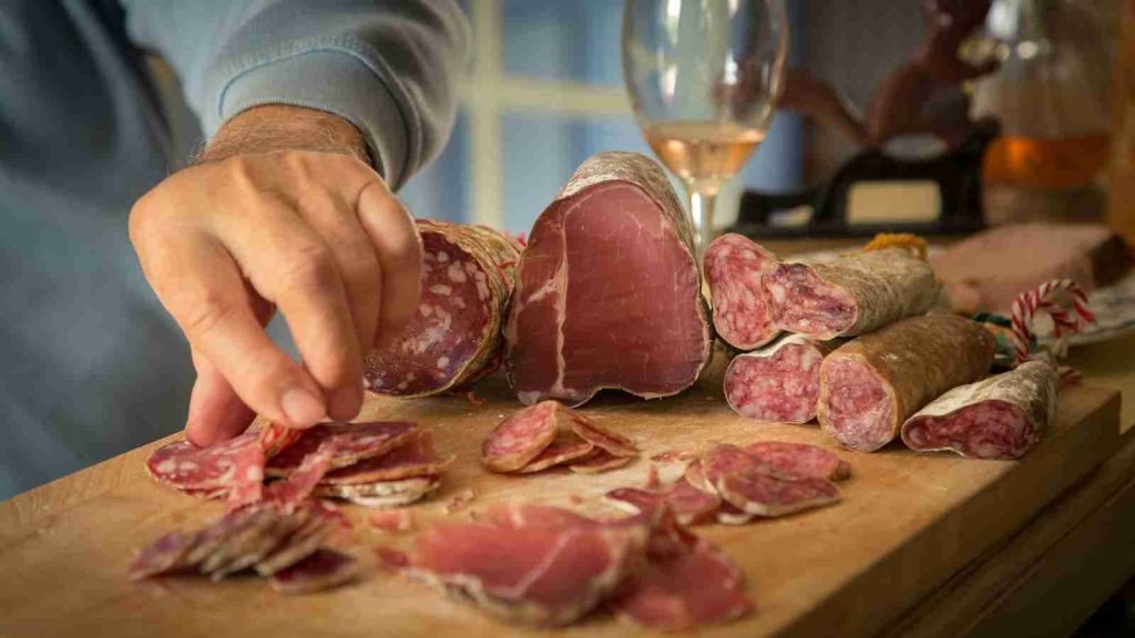 person slicing meat