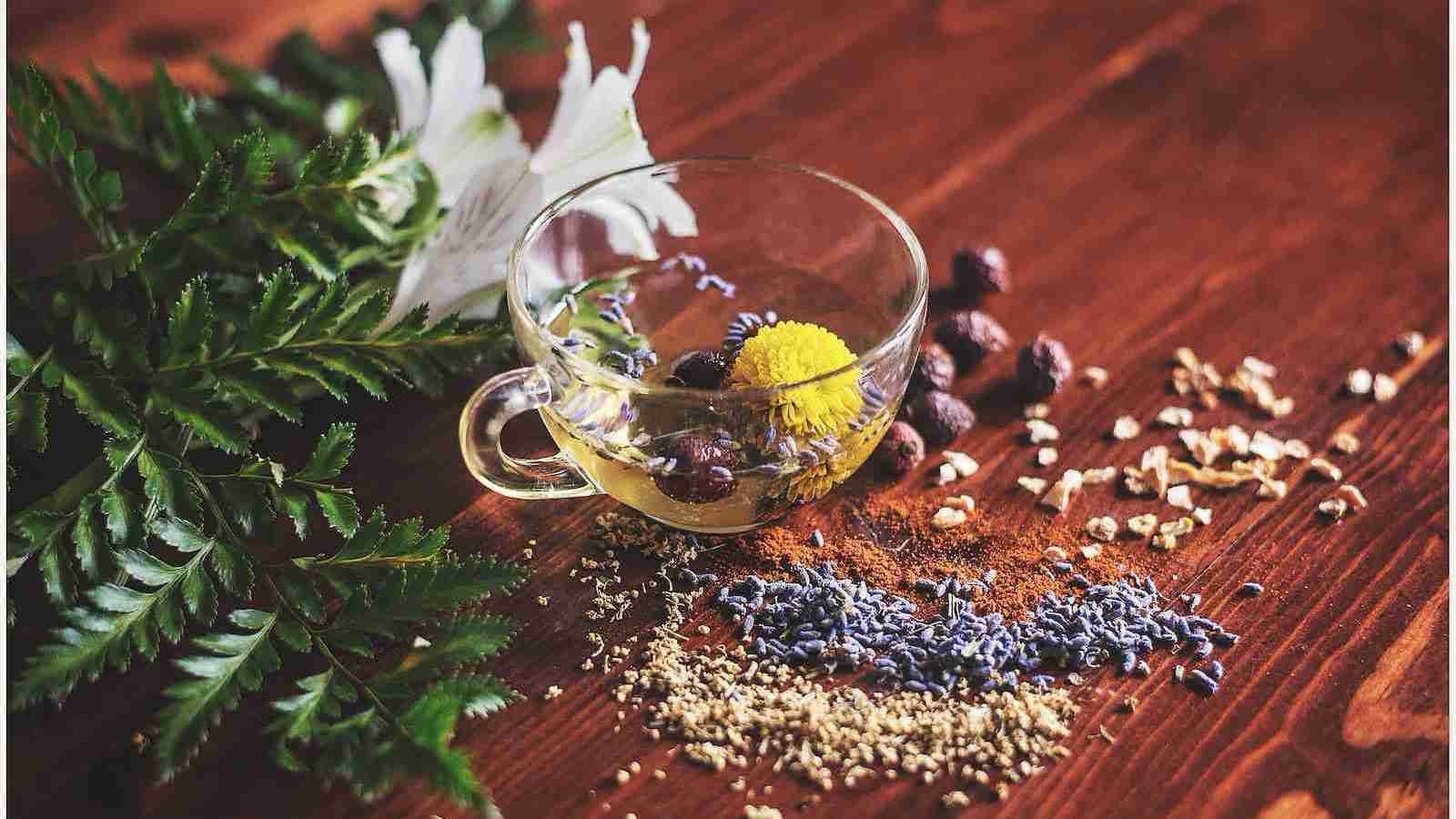  tea cup on brown surface with chai seeds