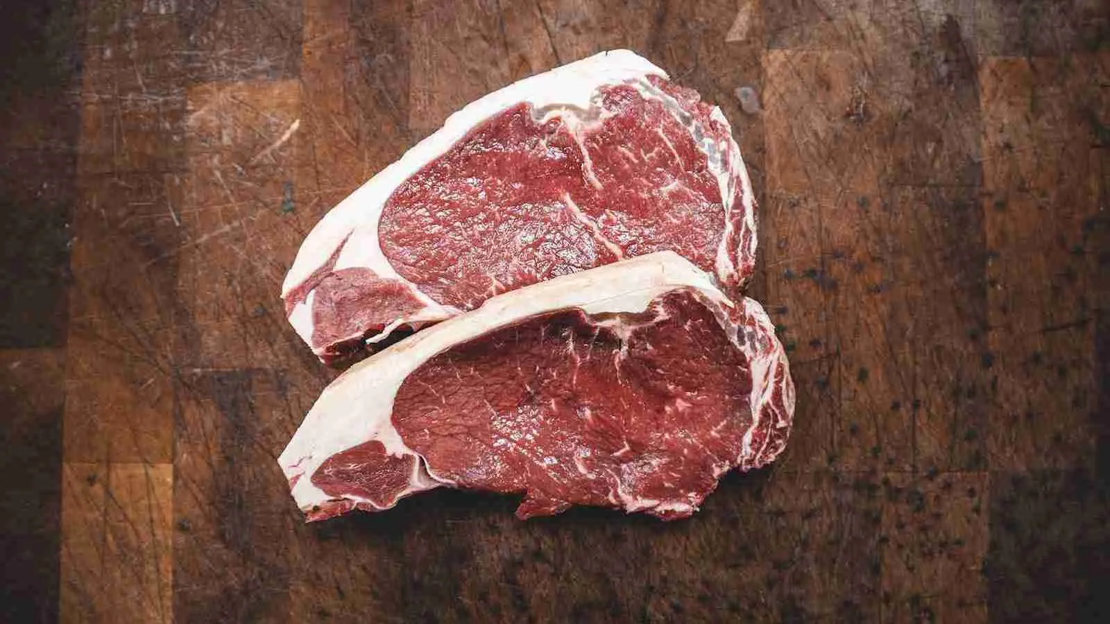 raw meat on brown wooden table