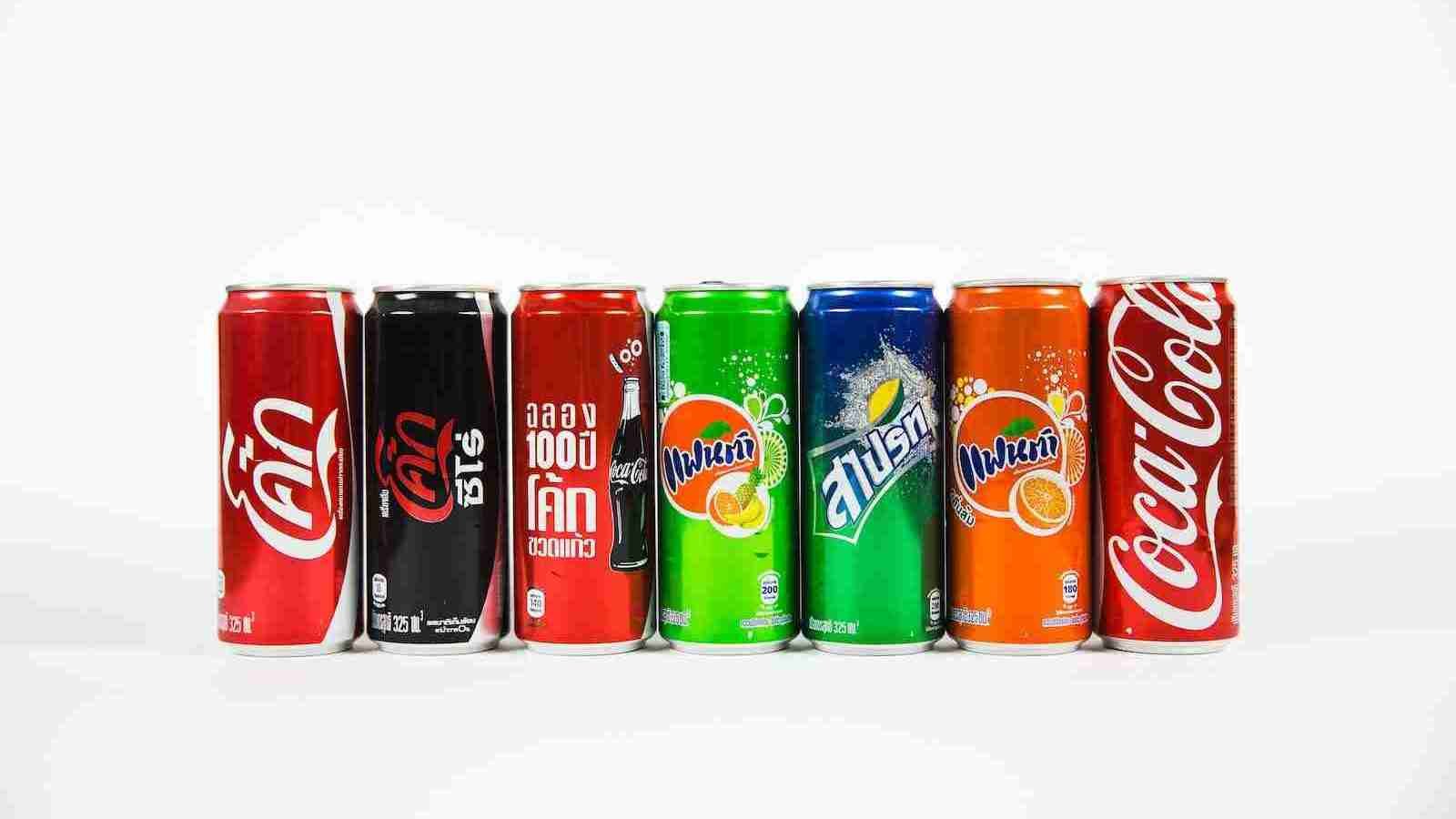 seven assorted-brand soda cans