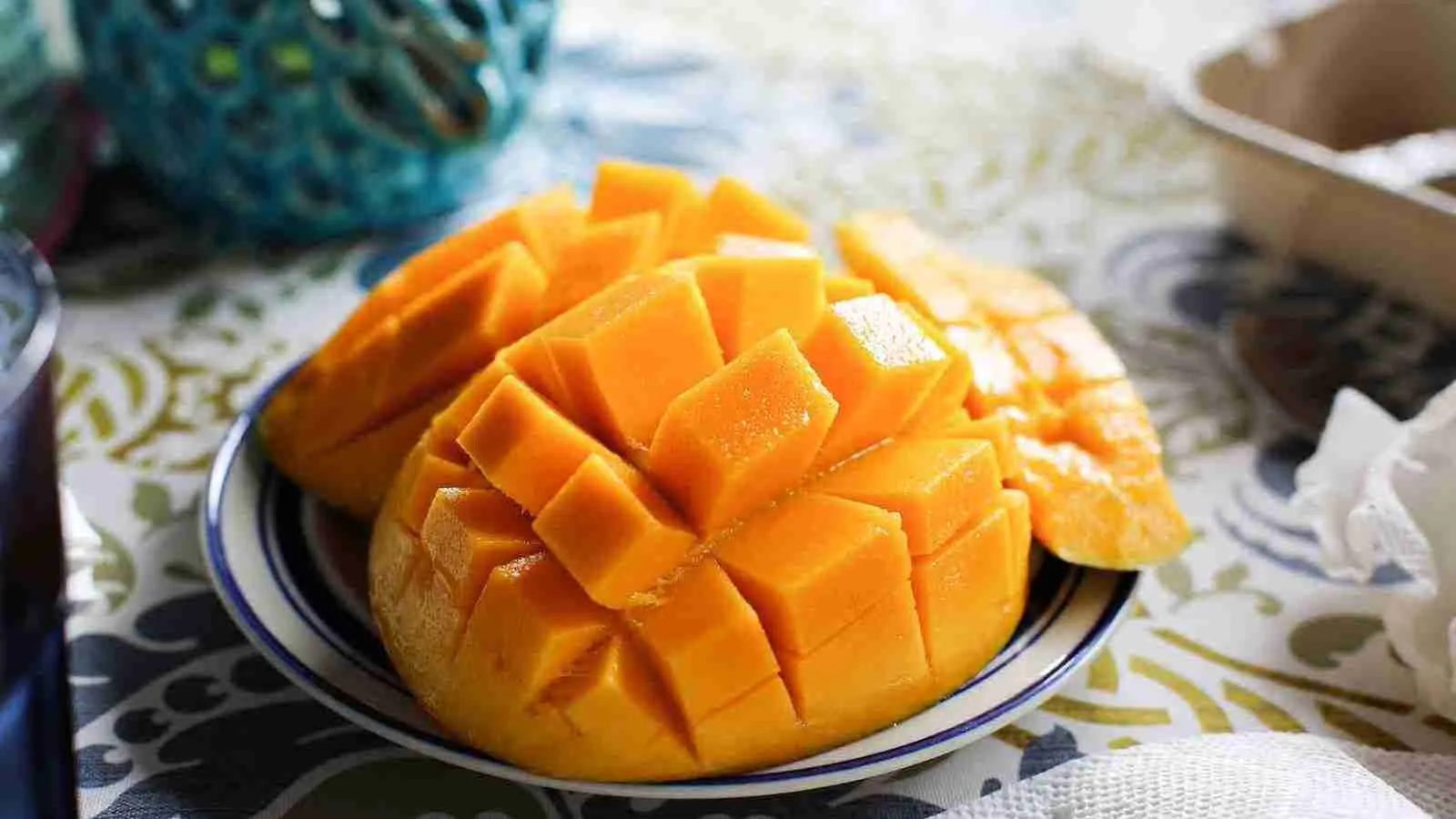 a close up of a plate of sliced mango on a table