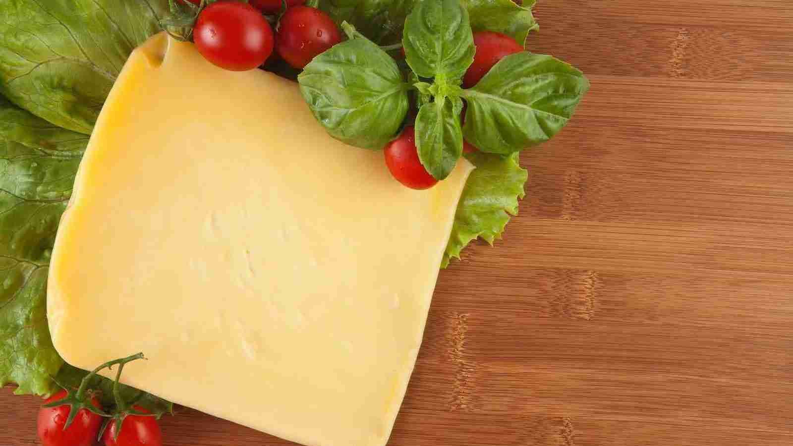 red tomato beside yellow cheese