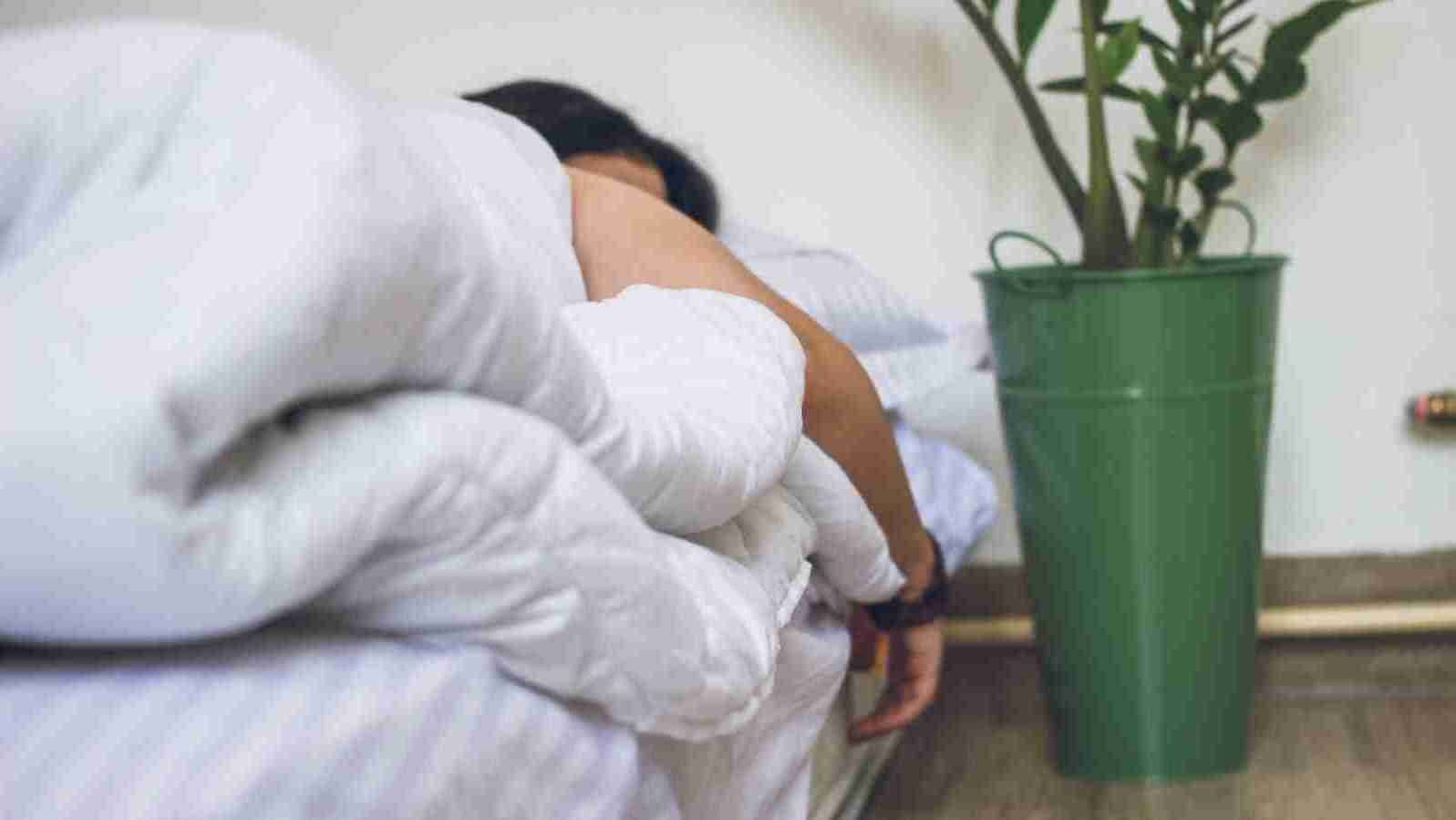a person sleeping in his bed.