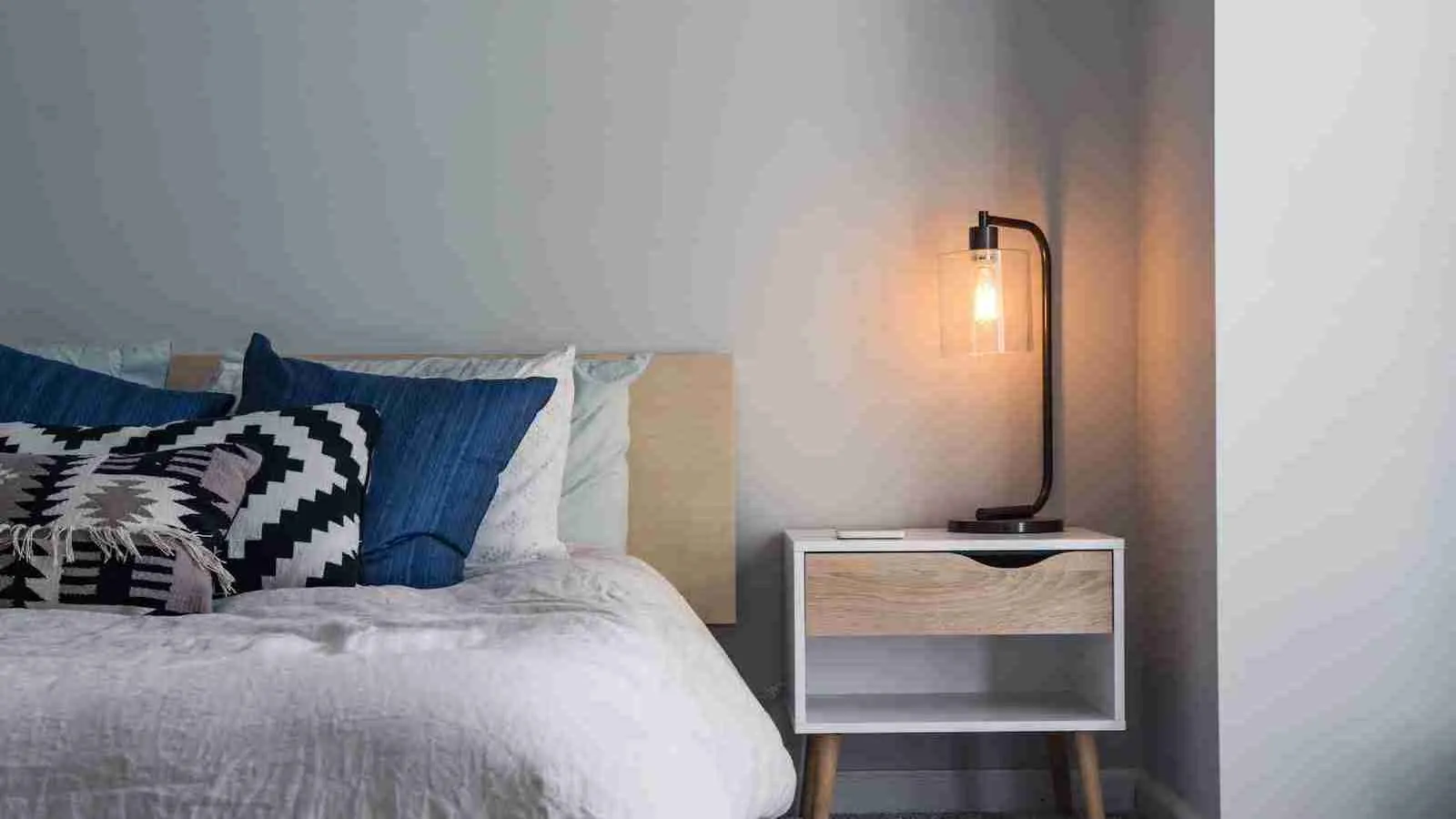 black table lamp on side table in a bedroom