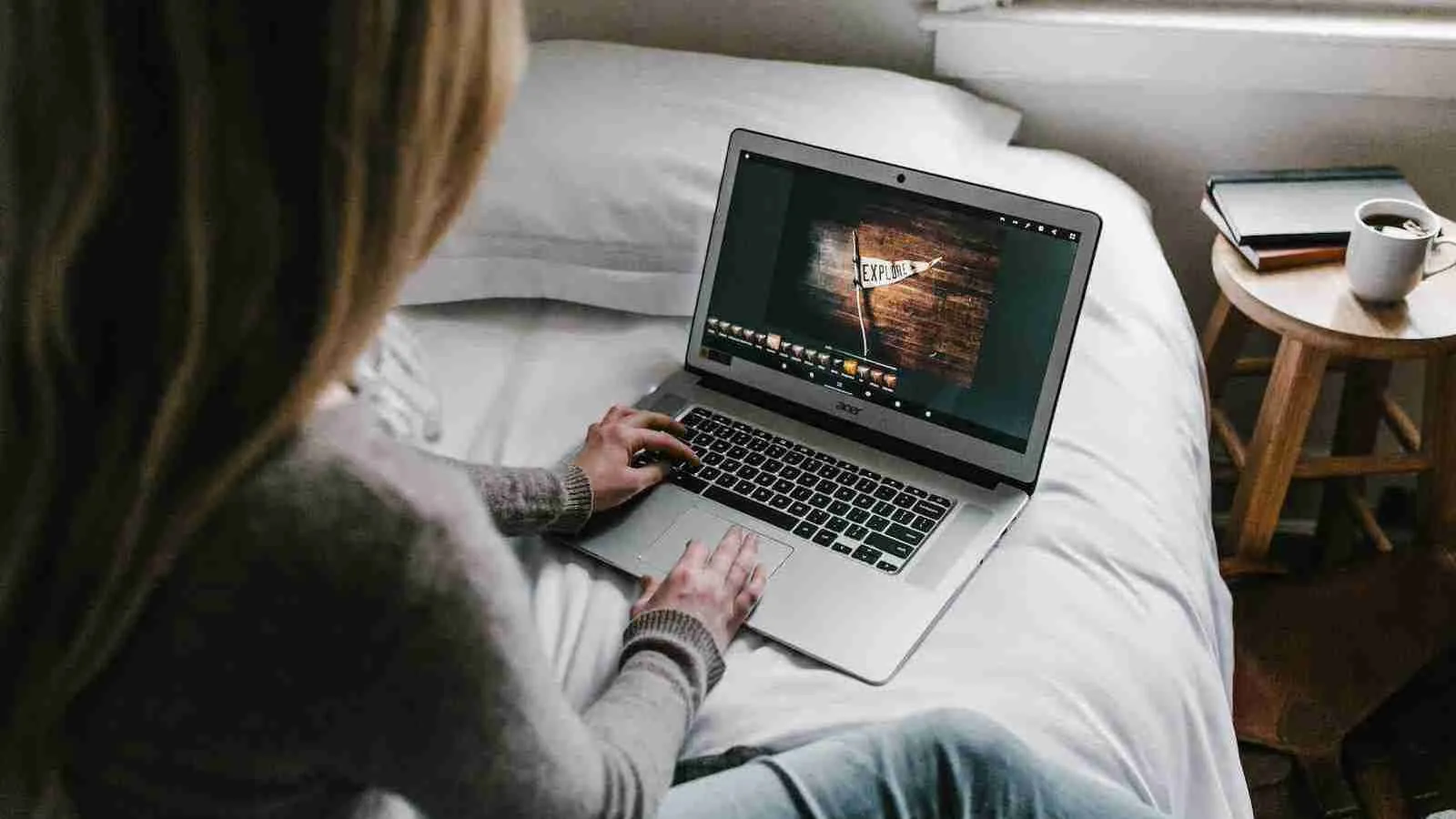 woman using gray laptop on bed